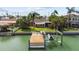 Waterfront home with a private dock, boat lift, and lush backyard, perfect for outdoor entertaining at 543 Crystal Dr, Madeira Beach, FL 33708
