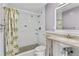 Bathroom featuring tiled shower, toilet, and single sink vanity at 543 Crystal Dr, Madeira Beach, FL 33708
