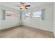 Bedroom with wood-look flooring, ceiling fan, and two large windows at 543 Crystal Dr, Madeira Beach, FL 33708