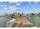 Wooden dock with boat lift providing direct water access and stunning neighborhood views of waterfront properties at 543 Crystal Dr, Madeira Beach, FL 33708