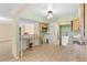 Open-concept kitchen featuring a dining area, wooden cabinets, and new flooring at 543 Crystal Dr, Madeira Beach, FL 33708