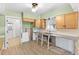 Kitchen with wooden cabinets, new flooring, and an open entrance to the living area at 543 Crystal Dr, Madeira Beach, FL 33708