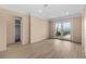 Bright living room featuring new flooring, neutral walls, and glass doors to the backyard at 543 Crystal Dr, Madeira Beach, FL 33708