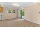 Bright living room with sliding glass door to backyard and light wood-look flooring at 543 Crystal Dr, Madeira Beach, FL 33708