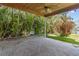 Covered brick patio surrounded by tropical landscaping and palm trees, offering a serene outdoor space at 543 Crystal Dr, Madeira Beach, FL 33708