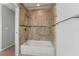 Bathtub shower combo featuring neutral tile surround, perfect for relaxation at 581 Oceanview Ave, Palm Harbor, FL 34683