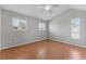 A simple bedroom with tile flooring, neutral paint, and windows for natural light at 581 Oceanview Ave, Palm Harbor, FL 34683