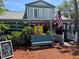 Charming building with an American flag, outdoor seating, and nautical decor at 581 Oceanview Ave, Palm Harbor, FL 34683