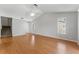 A bright, spacious living room with laminate floors, large windows, and a ceiling fan at 581 Oceanview Ave, Palm Harbor, FL 34683