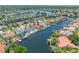 Stunning aerial view of a waterfront property with a private pool, boat dock, and canal access, set within a picturesque community at 5816 Dory Way, Tampa, FL 33615