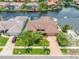 Aerial view of landscaped property featuring brick driveway and meticulous lawn at 5816 Dory Way, Tampa, FL 33615