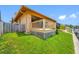 Exterior backyard view of the home featuring a wood deck, lawn, and waterfront access at 5816 Dory Way, Tampa, FL 33615