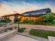 Backyard patio area at sunset with lush garden and enclosed patio at 5816 Dory Way, Tampa, FL 33615