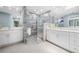 Modern bathroom with tiled walk-in shower, dual sinks, and elegant white cabinetry at 5816 Dory Way, Tampa, FL 33615