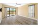 Light-filled bedroom with wood floors, a sliding glass door to the deck, and a ceiling fan at 5816 Dory Way, Tampa, FL 33615