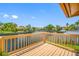 Waterfront deck offering serene views of the canal and lush landscaping under a blue sky at 5816 Dory Way, Tampa, FL 33615