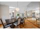 Dining room featuring wood floors, a large mirror, and a decorative chandelier at 5816 Dory Way, Tampa, FL 33615