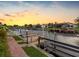 Scenic waterway with wooden dock at sunset with adjacent manicured lawn at 5816 Dory Way, Tampa, FL 33615