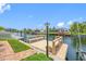 Wooden dock area overlooking the serene waterway with manicured lawn at 5816 Dory Way, Tampa, FL 33615