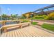 Wooden dock featuring a bench overlooking the serene waterfront and beautiful landscaping at 5816 Dory Way, Tampa, FL 33615