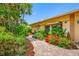 Charming home exterior with brick pathway and colorful, mature landscaping at 5816 Dory Way, Tampa, FL 33615