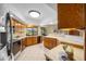 Kitchen featuring stainless steel appliances, tile floors, wood cabinets, and countertops at 5816 Dory Way, Tampa, FL 33615