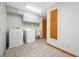 Functional laundry room equipped with washer, dryer, utility sink, and ample storage cabinets at 5816 Dory Way, Tampa, FL 33615