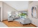 Bright living room featuring vaulted ceilings and sliding glass doors to pool area at 5816 Dory Way, Tampa, FL 33615