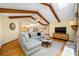 Spacious living room with wood beam ceilings, a gray sectional, hardwood floors, and modern entertainment setup at 5816 Dory Way, Tampa, FL 33615