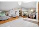 Bright and open living space with elegant flooring, modern lighting, and seamless flow to dining area, perfect for entertaining at 5816 Dory Way, Tampa, FL 33615