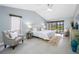 Bright main bedroom with sitting area, ceiling fan, and a sliding door leading to the pool at 5816 Dory Way, Tampa, FL 33615
