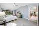 A spacious main bedroom with tile flooring, ceiling fan, and sliding door to the pool area at 5816 Dory Way, Tampa, FL 33615