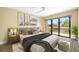 Tastefully decorated primary bedroom with a large bed, deck access, and views of the surrounding canal at 5816 Dory Way, Tampa, FL 33615