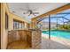 Outdoor kitchen and patio with in ground pool and landscaping at 5816 Dory Way, Tampa, FL 33615