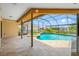 Inviting screened-in pool area with waterfall feature and attached spa provides a relaxing outdoor oasis at 5816 Dory Way, Tampa, FL 33615