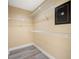 Empty walk-in closet features wood-look tile flooring, wire shelving, and built-in safe at 5816 Dory Way, Tampa, FL 33615