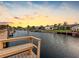 Scenic waterfront view with a wooden dock and bench, showcasing the tranquil canal and beautiful houses at 5816 Dory Way, Tampa, FL 33615