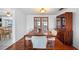 Bright dining room features a wood table with seating for eight and a beautiful dark wood cabinet at 5821 Thrush Dr, New Port Richey, FL 34652
