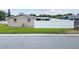 Exterior view of home showcasing white vinyl fence and mature landscaping at 5821 Thrush Dr, New Port Richey, FL 34652