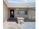 A home's inviting entrance showcases a stylish front door, textured walls, and decorative sconces at 5821 Thrush Dr, New Port Richey, FL 34652