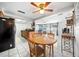 An open kitchen with black appliances, wood cabinets, and a dining area create a cozy and functional space at 5821 Thrush Dr, New Port Richey, FL 34652