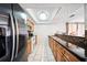 Kitchen with granite counters, stainless appliances, wood cabinets and seamlessly flowing into the living area at 5821 Thrush Dr, New Port Richey, FL 34652