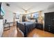 Well-lit main bedroom with matching dark furniture, hardwood floors and a ceiling fan for added comfort at 5821 Thrush Dr, New Port Richey, FL 34652