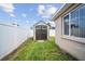 Backyard storage shed with double doors providing ample space for storing lawn care and garden equipment at 5821 Thrush Dr, New Port Richey, FL 34652