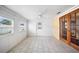 Bright sun room with tile flooring, white walls, a ceiling fan, and glass paneled doors at 5821 Thrush Dr, New Port Richey, FL 34652
