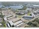 Expansive aerial perspective of a condo community situated by a scenic lake, with a lush landscape surrounding it at 6330 99Th N Way # 14F, St Petersburg, FL 33708