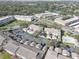 An aerial view of the condo complex featuring pools, parking areas, ponds, and lush green landscaping at 6330 99Th N Way # 14F, St Petersburg, FL 33708
