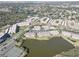 Scenic aerial view of lakeside community with mature trees and lush landscaping at 6330 99Th N Way # 14F, St Petersburg, FL 33708