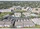 Aerial view of condo complex with community pool, lush landscaping, parking, and private driveways at 6330 99Th N Way # 14F, St Petersburg, FL 33708