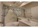 Bathroom showcasing a vanity, toilet, and bathtub-shower combination with a shower curtain at 6330 99Th N Way # 14F, St Petersburg, FL 33708